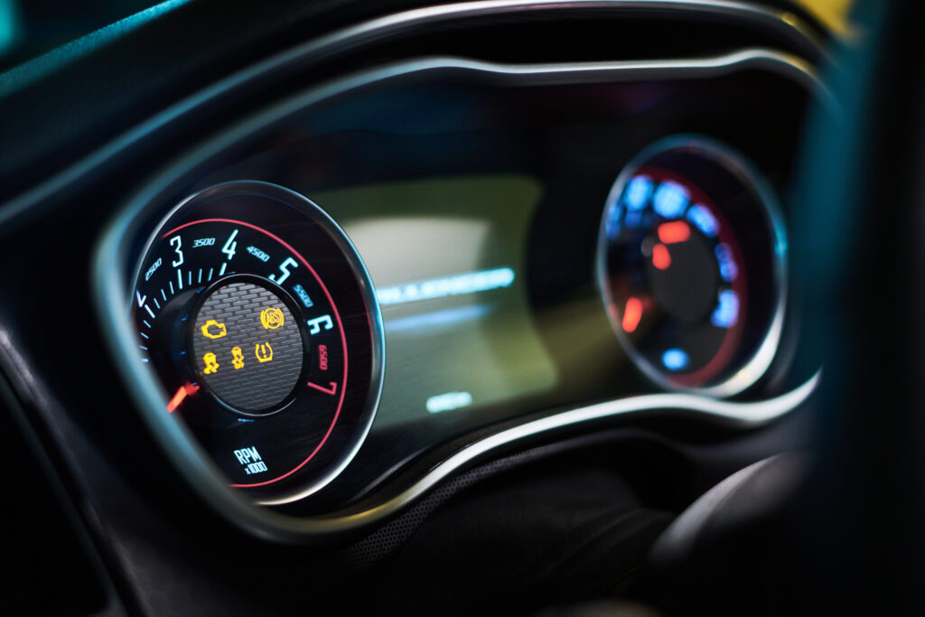 Car dashboard with multiple warning lights illuminated.